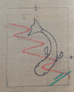 The same piece of canvas as before, now with a fish outlined over the curve.