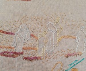 A portion of the embroidered depiction of an excavation in browns and golds, the figures surrounded by tiny seed stitches to bring to mind the cloud of dust that results from activity in dry earth.