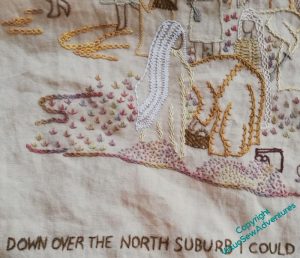 Close up of the lower left quadrant of the Map embroidery. The surtitle is in place, and there are tete de boeuf stitch plants all over the excavation.