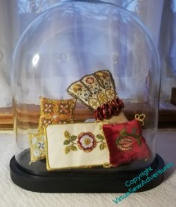 The Floral Glove, Tudor Rose panel, and three little cushions in Tudor goldwork, displayed under a parlour dome. They don't really fill it, so it looks a little half-hearted.