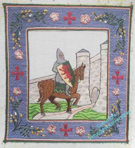 A knight on a bay horse approaches a castle. His shield is per pale gold and green, a lion rampant gules - the arms of William Marshall, 1st Earl of Pembroke. The border is blue, decorated with broom, dog roses, and crosses. All is rendered in silk.
The sky remains unstitched - it will be in gold underside couching.