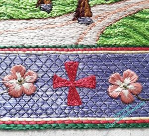 Close up of the border at the bottom of the panel. It shows the red cross filled in, and right at the bottom, a row of green split stitch, which may help when the piece is finally finished and mounted.