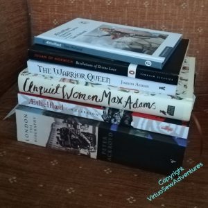 A pile of books on a chair, spines forward. You can see some of the titles - "Aethelflaed", "Unquiet Women", "The Warrior Queen", "Revelations of Divine Love"