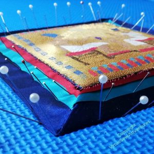 A forest of pins holding the ribbons in place on a large foam board.