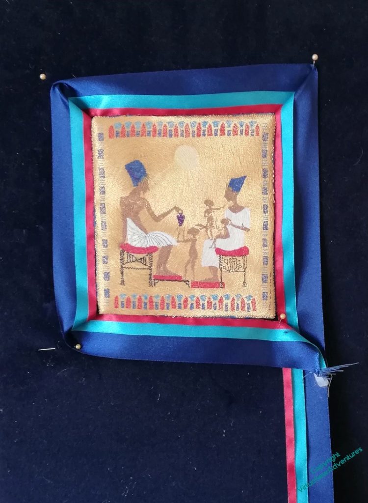 The Amarna Family Group, with a roughly attached ribbon frame.
