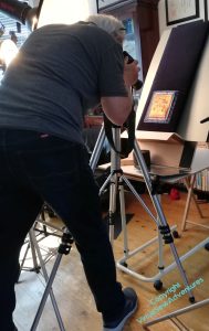 Photographer hard at work, the Family upside down on their easel.