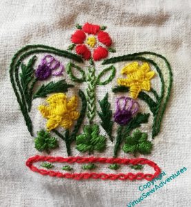 Rendition in stitches of the floral crown designed as part of the coronation logo.