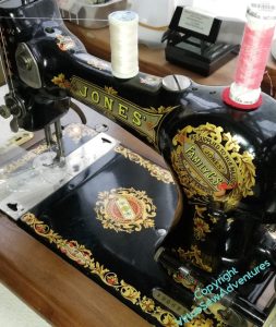 Lovely old sewing machine, a Jones, black enamel and gold highlights