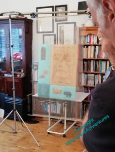 The first of the main panels, set around the Map of Amarna, is set up vertically on a table, and the gauze overlay of Nefertiti is suspended from a framework of pipes and clamps. You can just see the photographer to the side and frome the back.