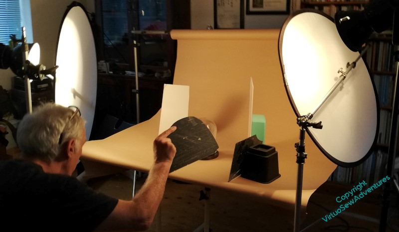 Photograph of the set up needed to get the professional photo, with mirrors and reflectors all around.