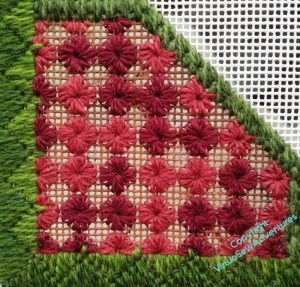 Small corner border in Squared Daisies stitch in two shades of burgundy, with the threads between them uncovered.