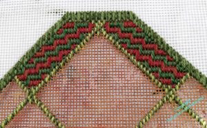 The two innermost external borders filled in Victorian Step Stitch, in alternating rows of green and reddish brown, mirrored across the centre line.