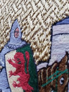 Close up view of William, his shield, his horse's head, and his armour, with the basketweave underside couching around him