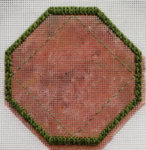 Octagonal shape outlined with mosaic stitches, with some borders tacked in with stranded cotton.