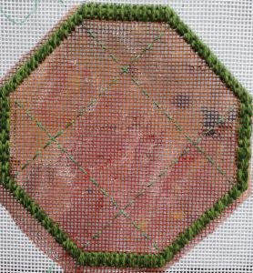 Octagonal shape outlined with mosaic stitches, with some borders tacked in with stranded cotton.