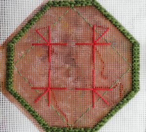 Octagonal shape outlined with mosaic stitches, with some borders tacked in with stranded cotton, and further stranded cotton outlining of a very large stitch motif, experimenting with placement.