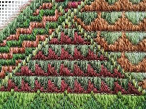 The last division of one of the long borders, worked in a stitch called "Wild Goose Chase". All the wool used is multiple strands in different shades to create a more varied effect.