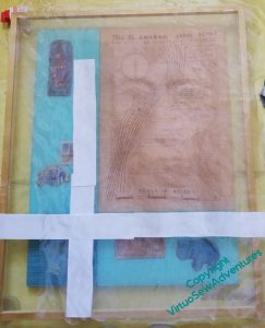 The panel of the Map, with a secondary gauze of Akhenaten laid over the top, and some paper helping to mark where it is to lie.