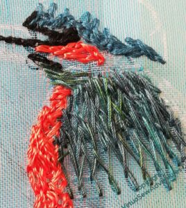 Close up of the wing and head of the kingfisher, showing details of the stitching.