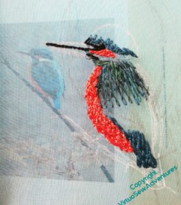 The start of the second version of the kingfisher on gauze. You can see the photograph I've based it on through the fabric