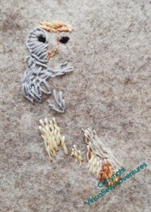 More stitching in place, in particular dark eyes, so now it's clear it's going to be an owl.