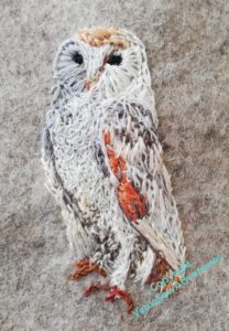 The owl now has legs and feet, and much finer stitchery over the soft feathers of the breast.