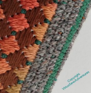 Shot showing the grey edging stitch against the ornamental stitching on the front.
