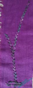 Long photo of a vaguely tree like motif in Mountmellick Thorn Stitch