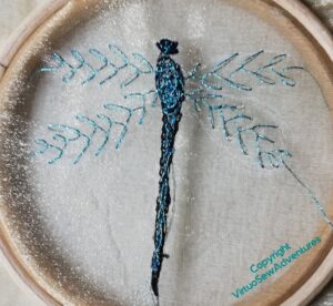 The first dragonfly finished. The sparkly threads make the stitches on the body hard to see.