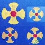 Vague designs of a curved edged, garnet centred cross