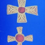 Two garnet centred gold cross designs patterned after one in the Staffordshire Hoard