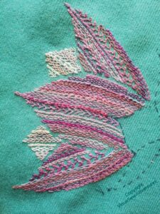 Half-open lotus flower in lilacs and purples