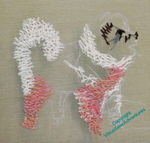 I've now started putting orangey stitches on the figure of the dog. The two nearest legs are done.