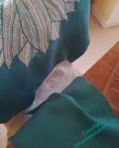 Jacket back hanging over a chair, dart for the collar in the foreground