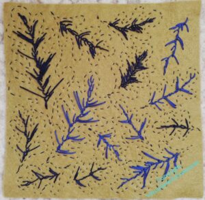 A sheet of felt with leaves stitched on it.